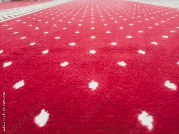 Fototapeta The texture of the red carpet with a white dot motif neatly arranged in a straight line gives an elegant impression as a background for industrial product catalog design.