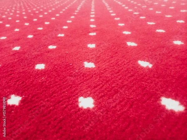 Fototapeta The texture of the red carpet with a white dot motif neatly arranged in a straight line gives an elegant impression as a background for industrial product catalog design.