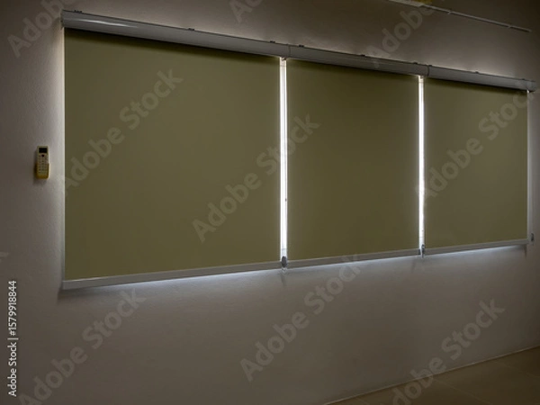 Obraz Closed roller blinds, three white curtain or white blinds Roller, sun protection in the dark room, office or meeting room background with nobody.