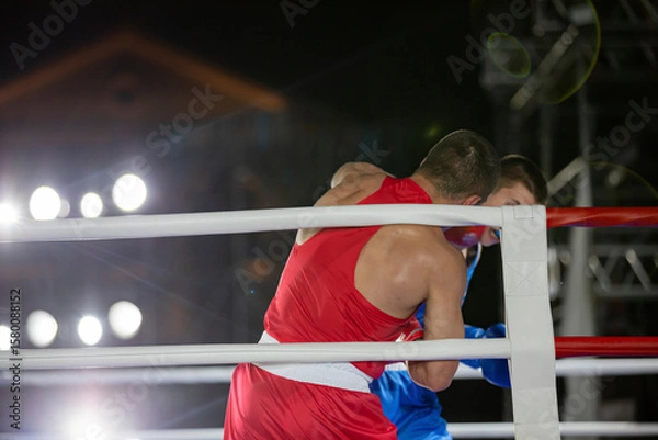 Obraz Boxing fight of two athletes in gloves in the ring