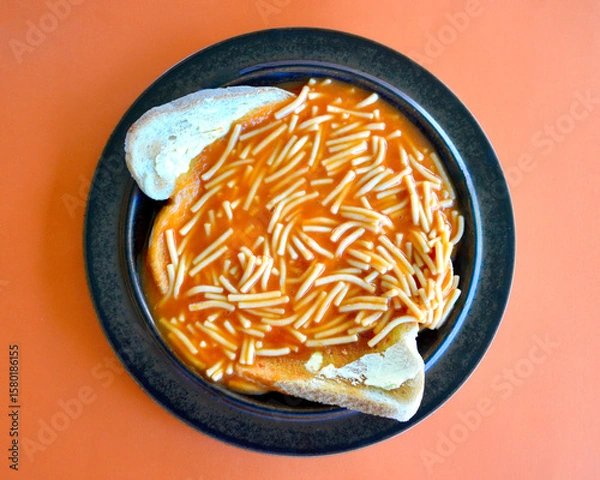 Obraz  top view of tinned spaghetti on lightly toasted bread with butter.