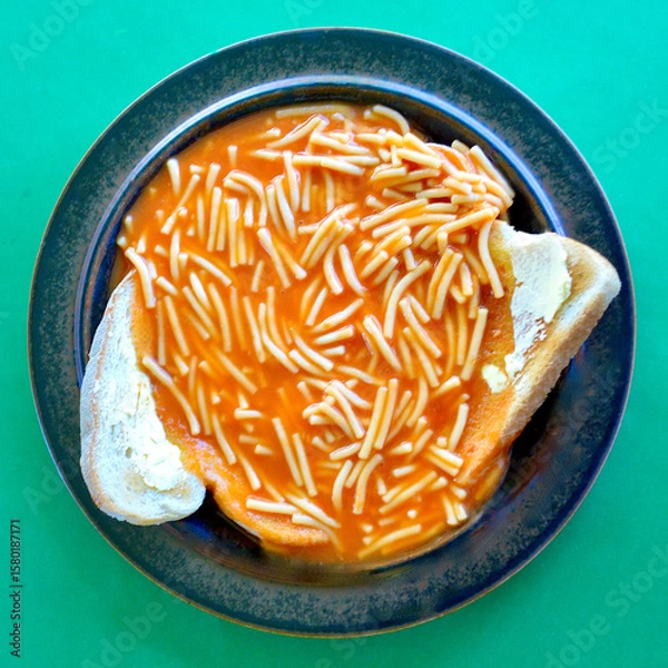 Fototapeta  top view of tinned spaghetti on lightly toasted bread with butter.
