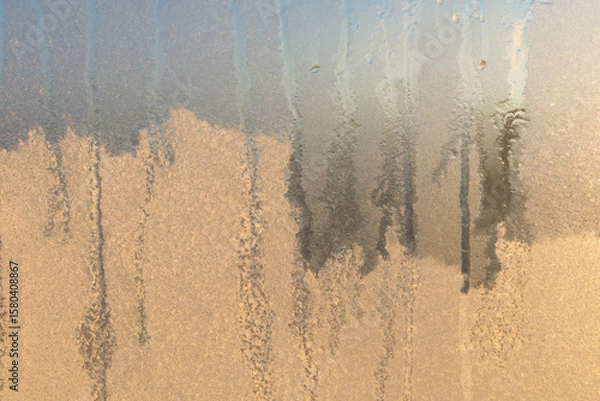 Fototapeta Window with frozen condensation on it.