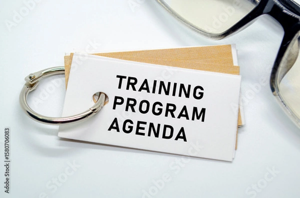 Fototapeta Training Program Agenda on notepad with keyring