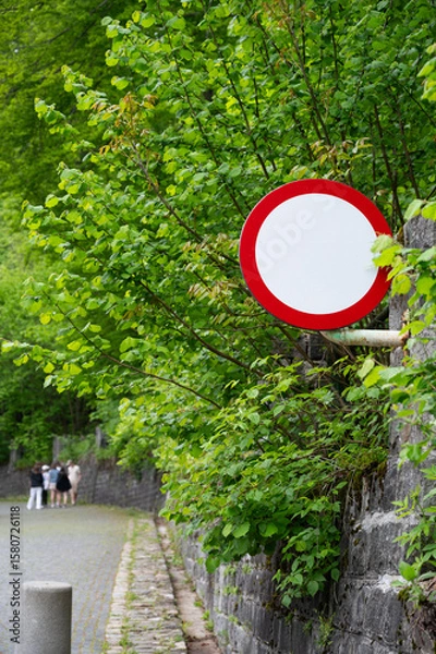 Fototapeta Vibrant road sign with a red border is designed to warn the driver about a section of the road with a high concentration of accidents
