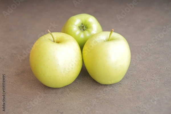 Obraz green apples on a yellow background