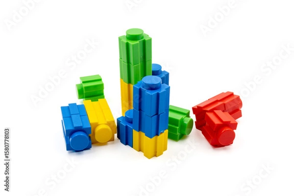 Fototapeta Colorful stacked plastic building blocks on white background