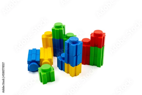 Fototapeta Colorful stacked plastic building blocks on white background