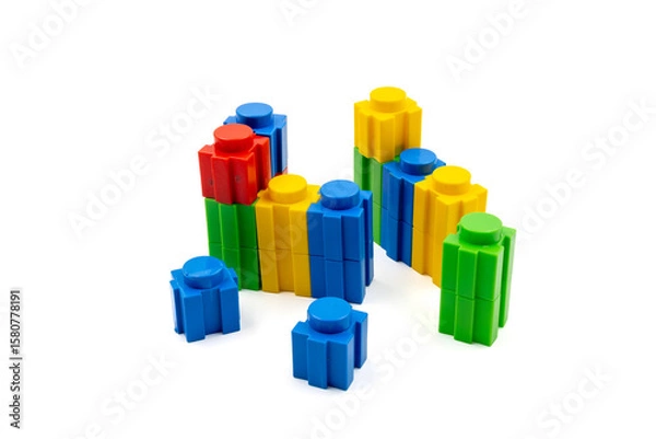 Fototapeta Colorful stacked plastic building blocks on white background