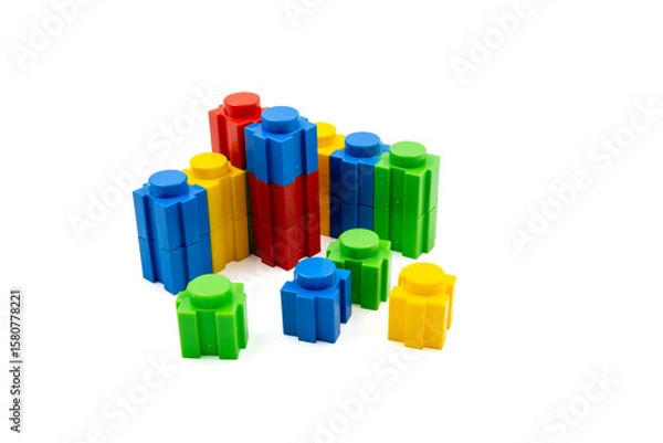 Fototapeta Colorful stacked plastic building blocks on white background