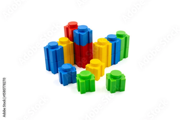 Fototapeta Colorful stacked plastic building blocks on white background