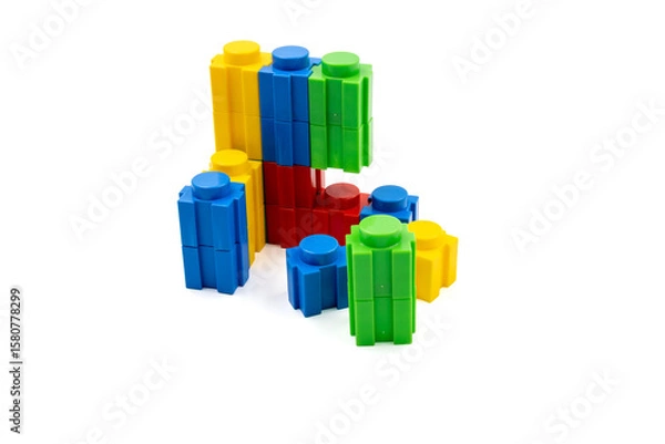 Fototapeta Colorful stacked plastic building blocks on white background