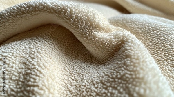 Fototapeta Close-up of creamy white sherpa fleece fabric texture offering softness and warmth for textiles
