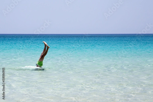 Fototapeta Man taking a dive