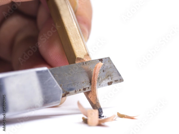 Fototapeta sharpened wooden pencil by cutter knife  close-up on white background