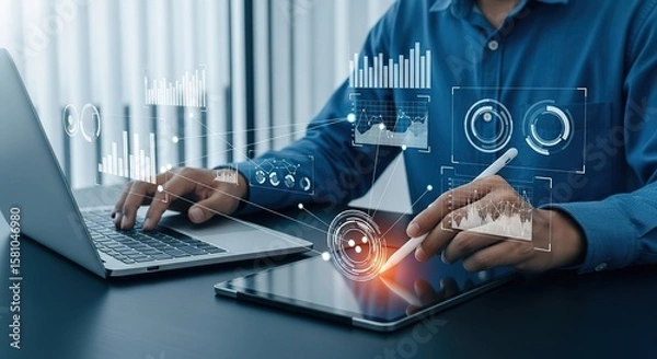 Fototapeta Businessman interacts with futuristic holographic data visualizations on a tablet and laptop for business analytics