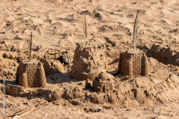 Fototapeta A sand castle remains after a weekend in early July on the beach at Harrington Beach State Park, Belgium, Wisconsin