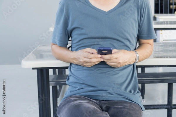 Fototapeta Young man using smart phone.
