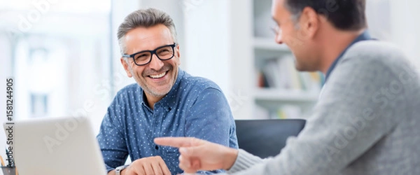 Fototapeta Partners in Progress: Two professionals engaged in a productive meeting, with smiles and collaboration, showing a moment of insight and shared understanding.
