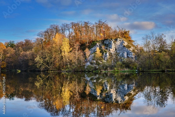 Fototapeta Gorgeous view of lake and autumn forest park, shadow reflecting on water surface.