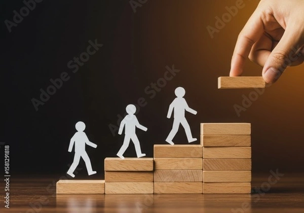 Obraz Paper people climbing wooden stairs as a hand adds the next step isolated on transparent background