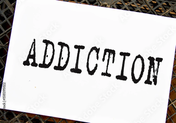 Obraz ADDICTION - word on white sheet on black grid background