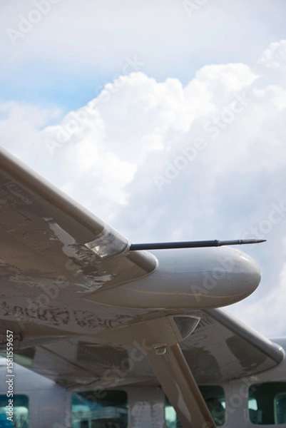 Fototapeta Close-Up of Aircraft Wing with Pitot Tube and Cloudy Sky