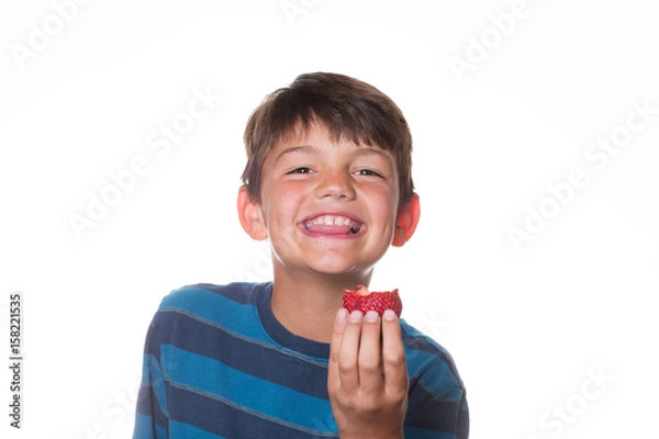 Obraz Boy smiling and holding up a strawberry