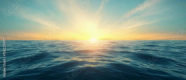 Fototapeta A serene ocean view at sunrise with calm waves reflecting the vibrant colors of the sky and sun.