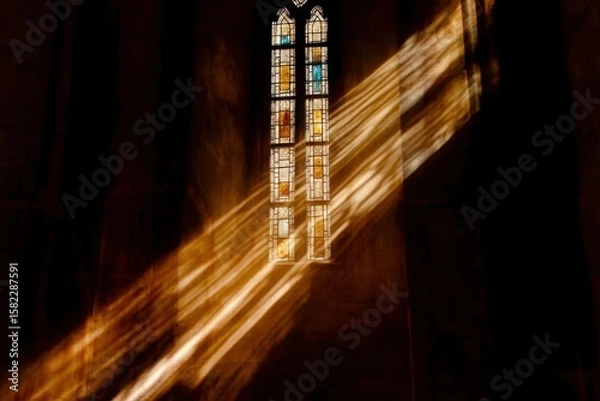 Obraz Sunlight streaming through stained glass in a minimalistic design