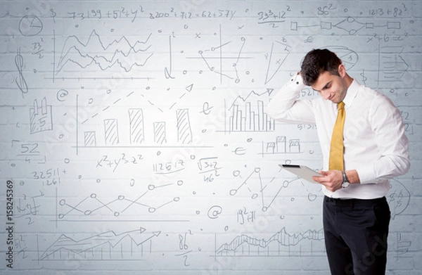 Fototapeta Salesman standing with drawn graph charts