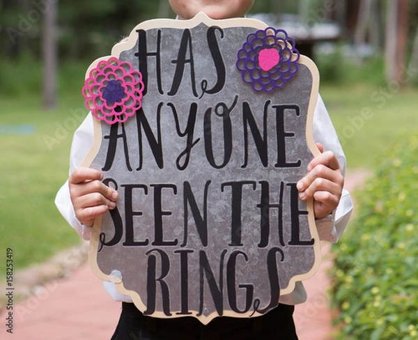 Fototapeta Has Anyone Seen the Rings Sign held by ring bearer