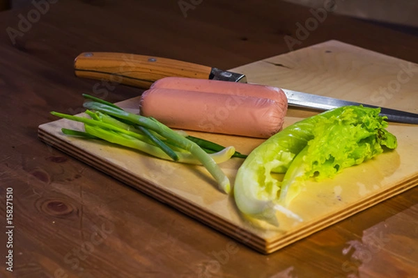 Obraz Products on a cutting board salad, onion, and knife
