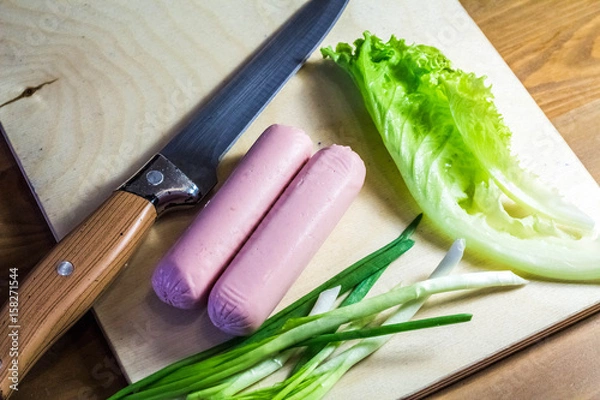 Obraz Products on a cutting board salad, onion, and knife