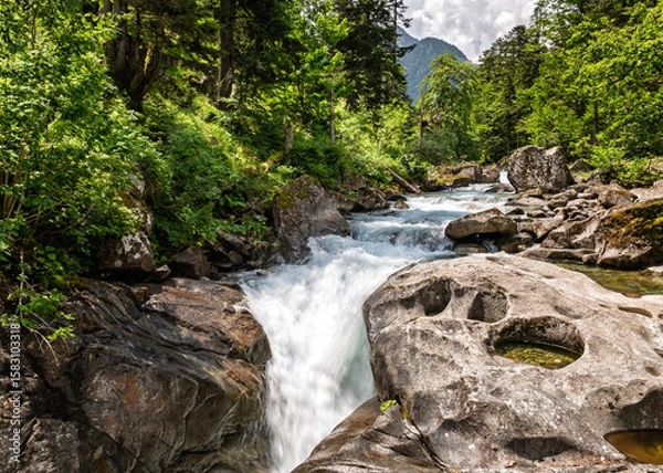 Fototapeta The Gave de Marcadau river flows over the Cascade du Pas de l'Ours in the Val de Jeret in the French Pyrenees