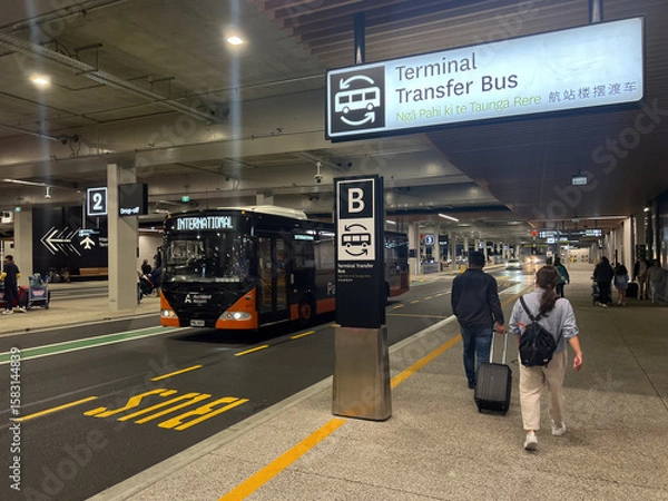 Fototapeta Tourists at Auckland airport bus stop New Zealand