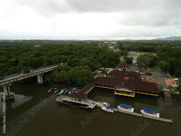 Fototapeta Morning traffic on bridge with river and mangrove area.