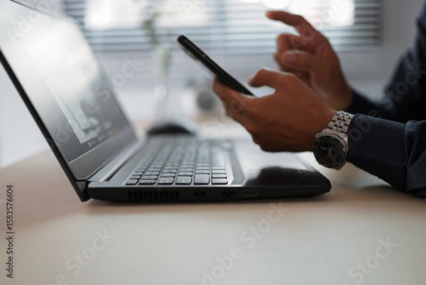Fototapeta The hand of Asian woman holding a mobile phone and press, slide or touch screen for searching about shopping online, chat to lover, prepare information for present to report or using internet banking