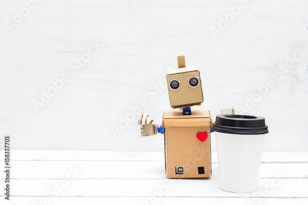Obraz Robot with a heart drinks coffee and eats candy