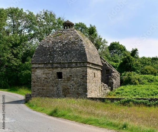 Fototapeta Historic dove cottage in need ot restoration