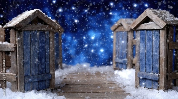 Fototapeta Two rustic wooden doors standing in a snow-covered landscape under soft daylight.