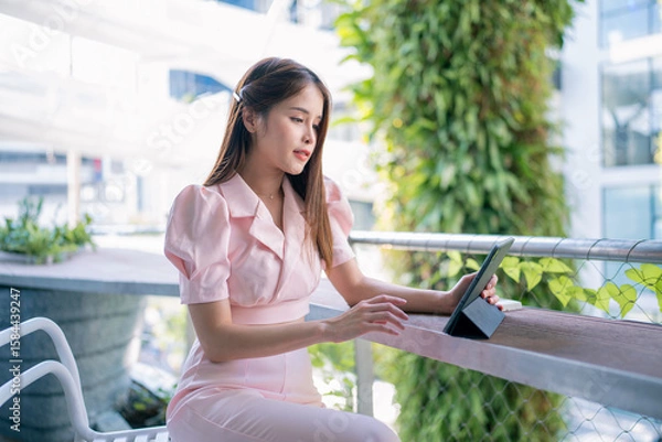 Obraz Shot of elegant business woman smiling and using tablet.