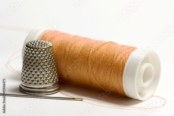 Obraz Orange sewing thread needle and thimble