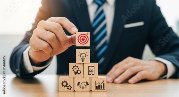 Obraz Businessman stacking wooden blocks with business strategy icons on them