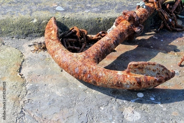 Obraz Rusty old disused anchor on a quayside