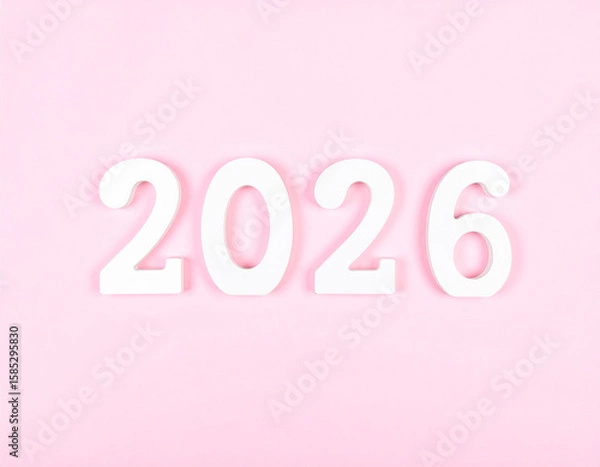 Fototapeta Flat lay of festive numbers 2026 on a pastel pink background celebrates the upcoming New Year with a cheerful vibe