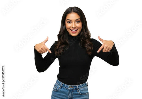 Obraz A smiling young woman with long dark hair points down with both thumbs, wearing a black turtleneck and jeans, isolated on a transparent background