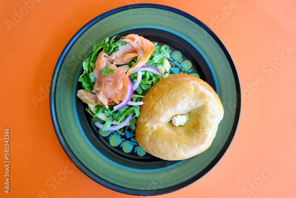 Obraz A salmon bagel with rocket and Spanish onion. 
