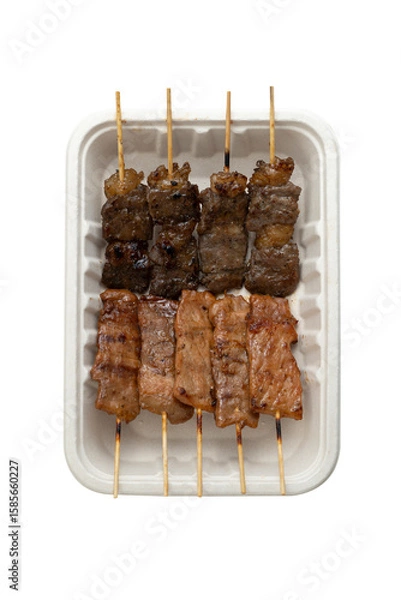Fototapeta Grilled meat on skewers in paper plate isolated on white