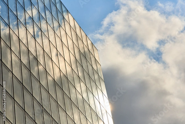Fototapeta Reflections of the Sky: A Play of Clouds and Sun